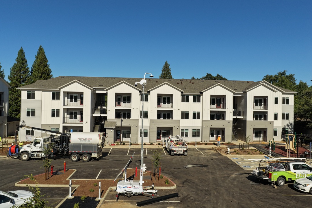 A large white building with a parking lot in front of it.